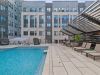The Main On university outdoor pool amenity with seating around the pool
